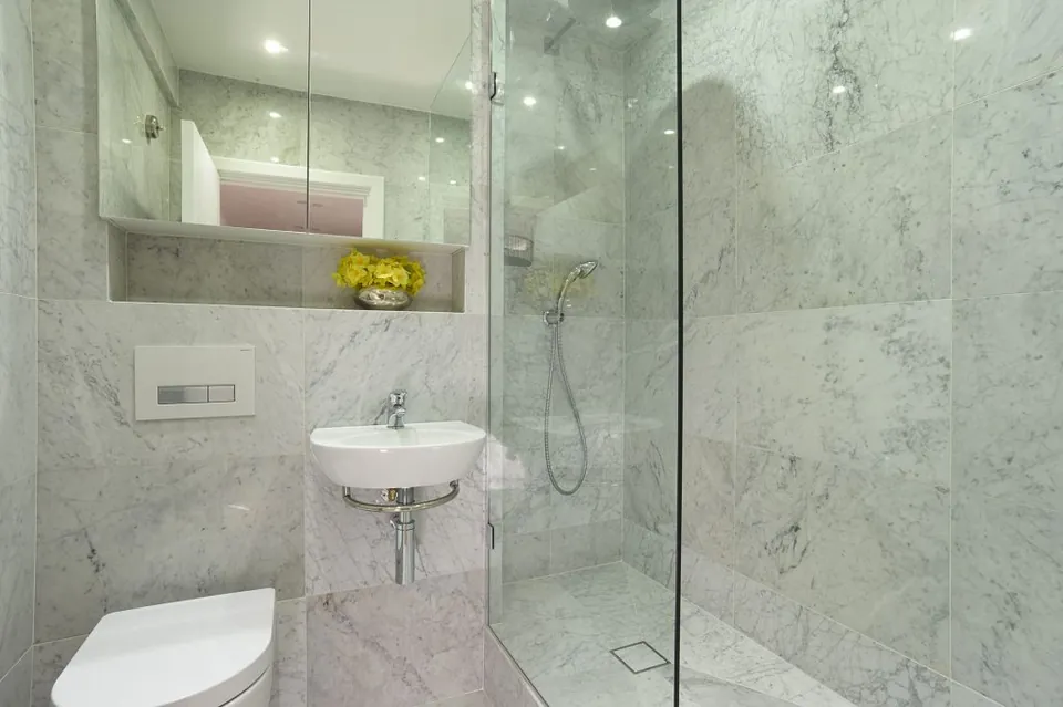 Grey marble wet room with a frameless glass screen