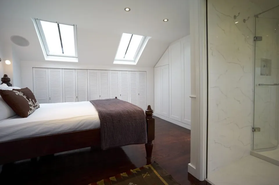 Bedroom with a glass-walled en-suite shower