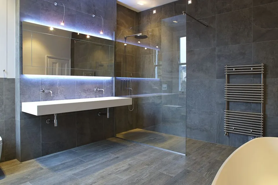 Large-format stone-effect wall tiles in a walk-in shower